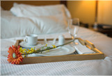 Photo of breakfast being served on a bed